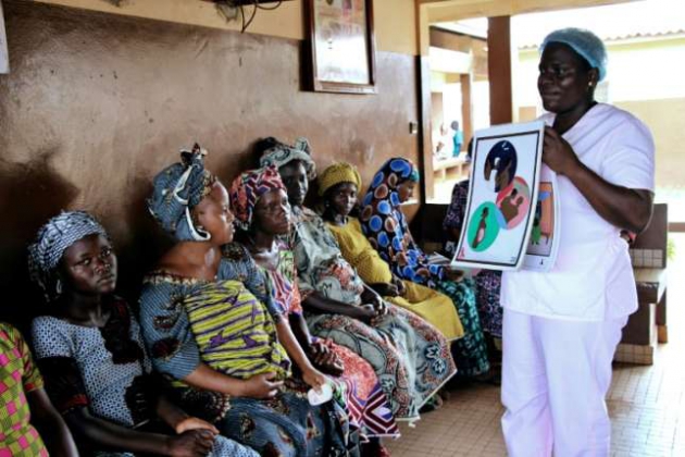 Blandine Mekpo, a midwife at a maternity ward, provides information about AIDS to pregnant women in Bohicon, southern Benin (AFP/File)