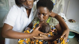 A nurse assists a young mother (courtesy guardian.ng)